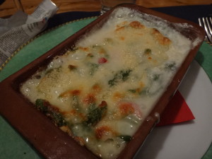 Spinach gnocchi with vegetables baked in a bubbling cream and cheese sauce.