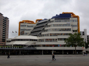 The Central Library was completed in 1981 and designed by Rotterdam Architect Bakema.  “The building is shaped like a cube with a cut off corner, a glass ‘waterfall’ where the escalators are located that connect the six floors” (Architecture in Rotterdam).