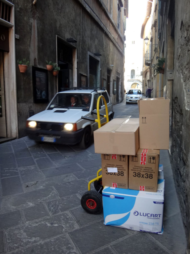 Traffic continues on the narrow streets of Todi even as goods are unloaded for local shops. Todi, Italy 2016