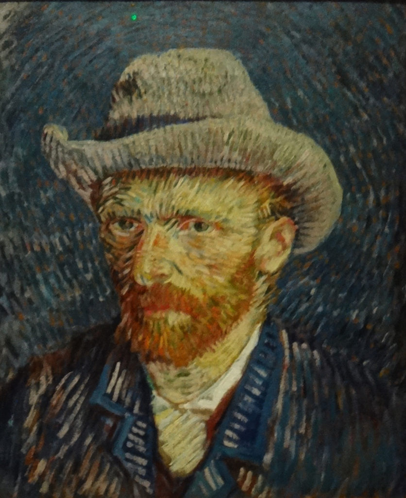 Self portrait with Grey Felt hat, 1887. A museum display says the painting is, "very accomplished and portrays a more elegant van Gogh (than an earlier self portrait). It is well-considered and neo-impressionist experiment in his new modern style and technique, executed in strong, contrasting colors and expressive brushstrokes."